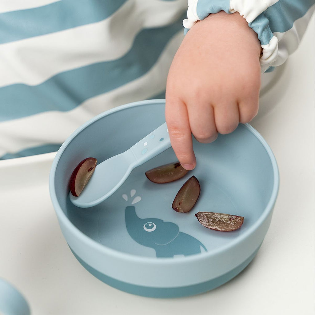 3-delt bestikksett Foodie Happy Dots i blått i barnets hånd
