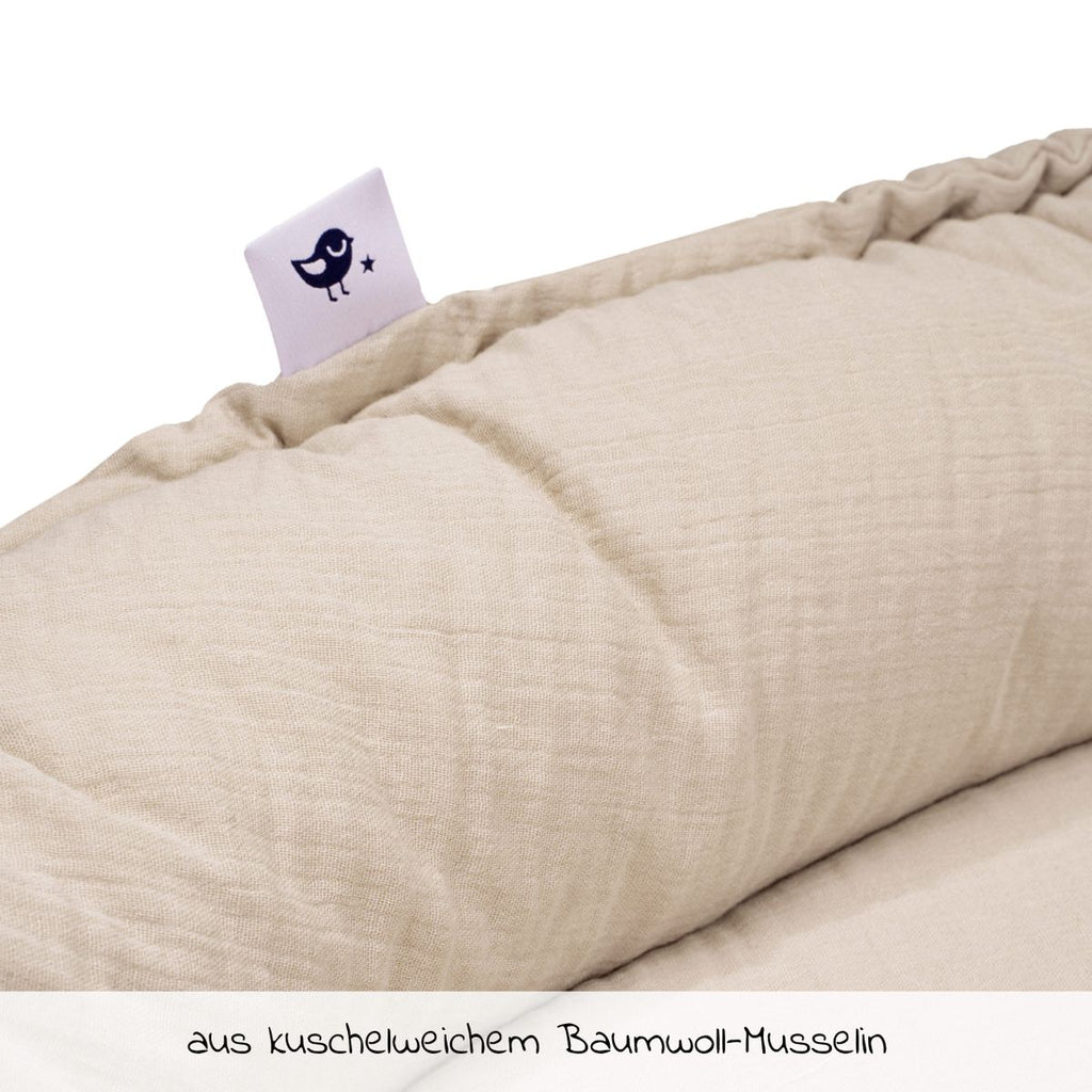 Babynest NIDO i bomullsmusselin, sand detalj av stoff