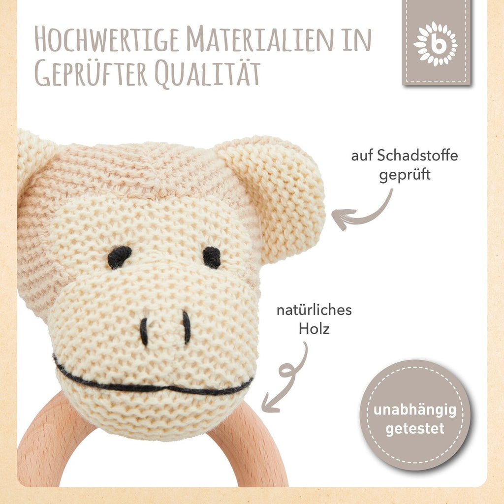 Nærbilde av gripering med rangle i tre og bomull, ape