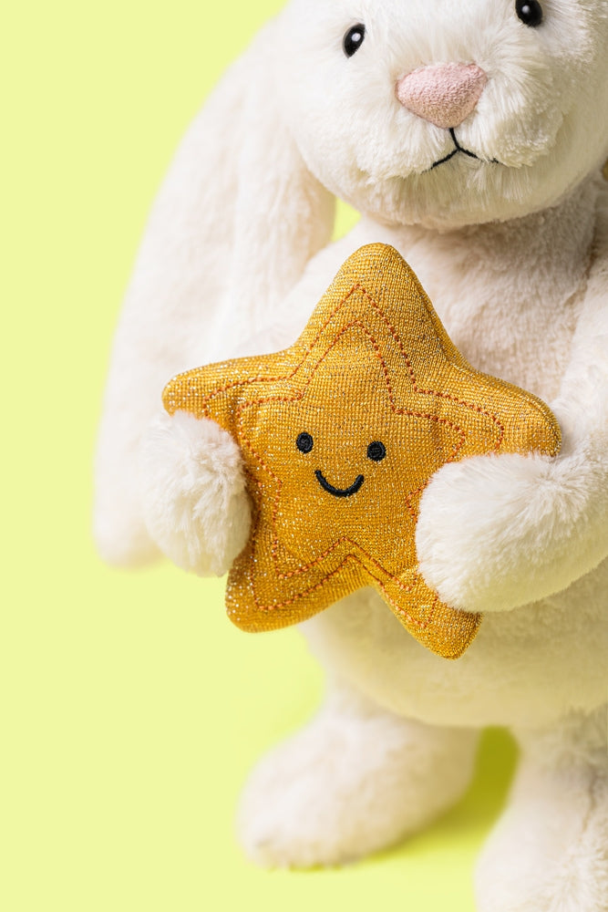 Nærbilde av mykt stoff på Kosebamse kanin med gullstjerne Jellycat