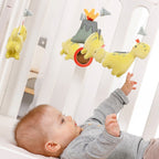 Montert Musikkuro Happy Dino med spilledåse på babybett