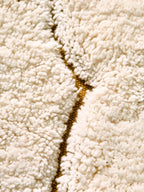 Detalj av skymotiv på rundt barneteppe skymotiv 100 cm bomull beige