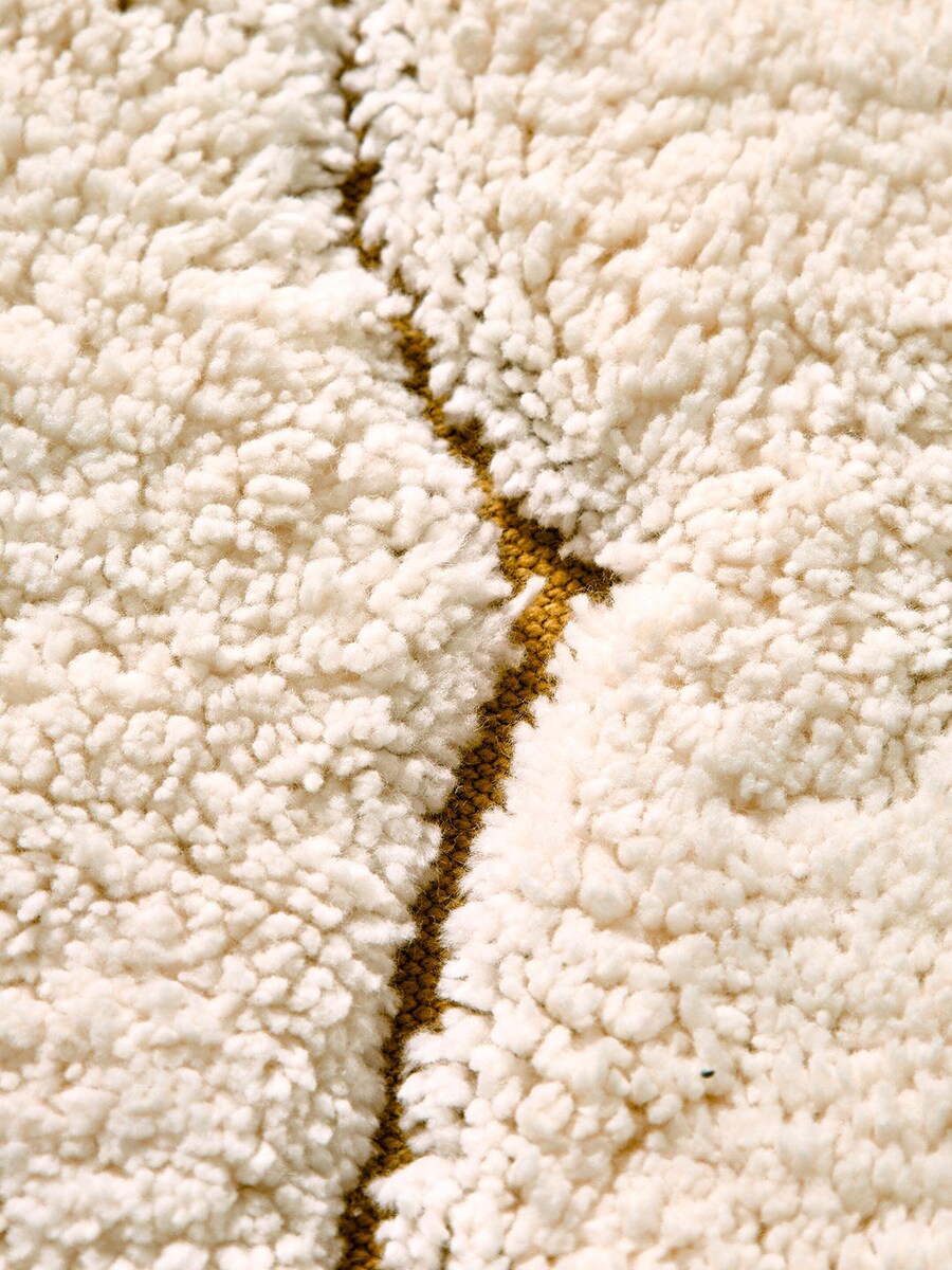 Detalj av skymotiv på rundt barneteppe skymotiv 100 cm bomull beige