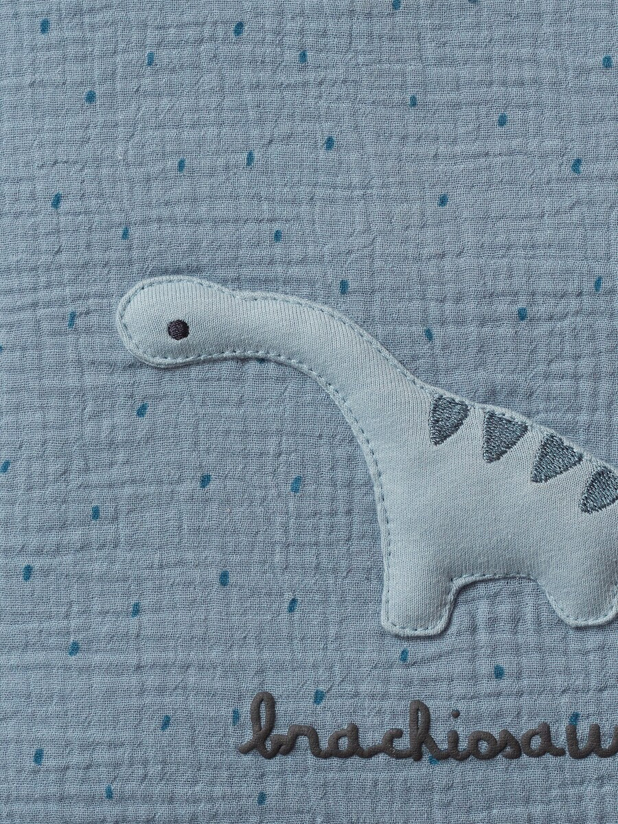 Nærbilde av stoff og borrelåsfeste på Sengebeskytter for sprinkelseng og lekegrind Liten Dino