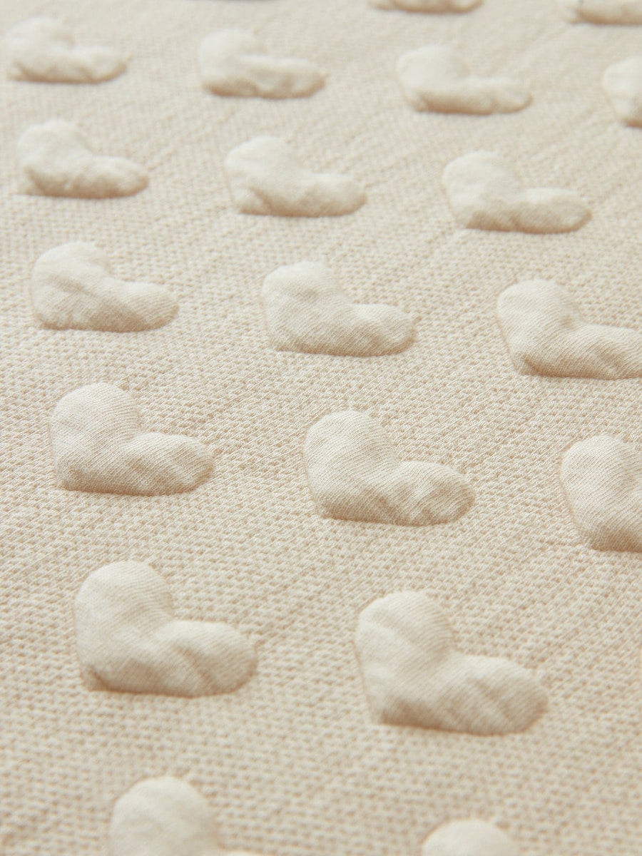 Detalj av Sovepose baby sommer JACQUARD jersey TOG 1 med jacquard-hjerter