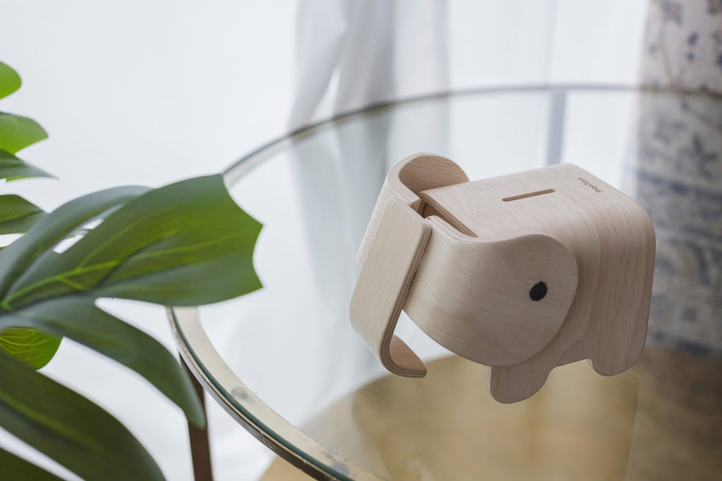 Nærbilde av sparebøsse elefant i tre PlanToys